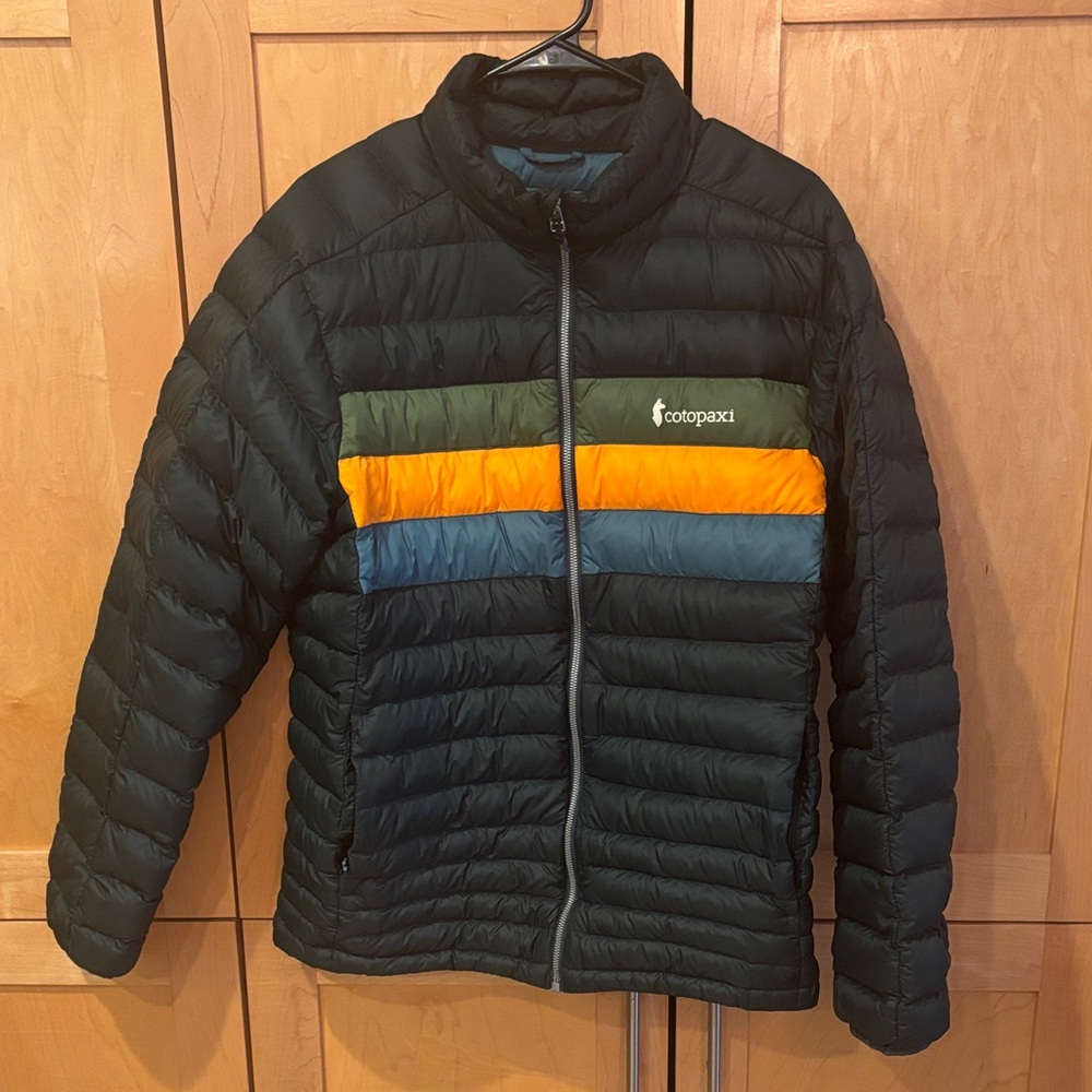 Cotopaxi Black Puffer Jacket with Orange and Blue Stripes
